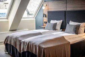 a large bed in a room with a large window at Quality Hotel Waterfront in Ålesund