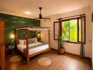 a bedroom with a canopy bed and a window at Tiki Beach Club & Resort in Paje +58 photos