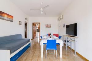 a room with a bed and a table and a tv at Annamaria House by BarbarHouse in Marina di Mancaversa