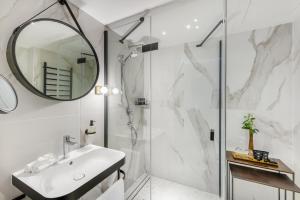 a bathroom with a shower and a sink and a mirror at Hotel Vinifera Wine & Spa 5 Stars Superior in Balatonfüred