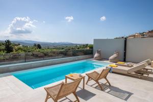 a villa with a swimming pool and a patio at Terra Falconis in Nipidhitós
