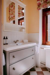 a white bathroom with a sink and a window at Oak House Vienna - Boutique Guesthouse near Meidling Station in Vienna
