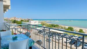 a balcony with a table and a view of a parking lot at Casa Ada in Termoli