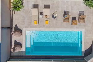 a blue swimming pool in a room with furniture at Terra Falconis in Nipidhitós +12 photos