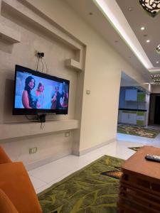 a living room with a flat screen tv on a wall at See side view city square 42 in Alexandria