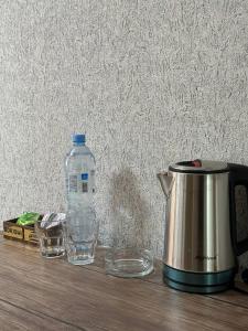 a bottle of water and two glasses on a table at Ситора in Dushanbe +19 photos