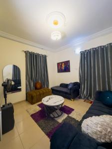 a living room with a couch and a table at PeaceNest in Idowu