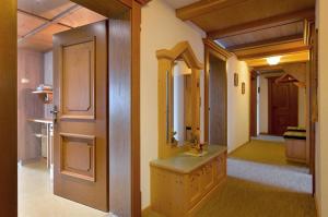 a hallway with a bathroom with a sink and a mirror at Ferienwohnung Kainer in Ried im Zillertal +46 photos