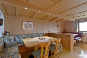 a living room with a table and a couch at Ferienwohnung Kainer in Ried im Zillertal