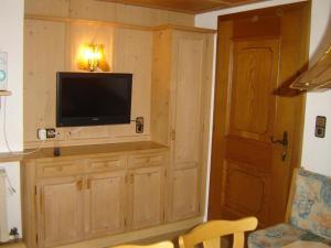 a living room with a flat screen tv on a wall at Ferienwohnung Kainer in Ried im Zillertal