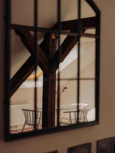 a mirror reflecting a table and chairs in a room at Oak House Vienna - Boutique Guesthouse near Meidling Station in Vienna