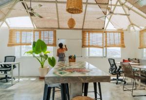 a woman in an office with a table and chairs at Outsite Todos Santos - Formerly Perro Surfero Hotel Boutique in Todos Santos