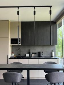 a kitchen with a table and chairs in it at Neboskhyl House in Khorosno