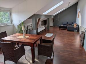 a living room with a wooden table and chairs at Lüsser Landsitz in Bad Belzig