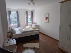 a bedroom with a bed and a window at Lüsser Landsitz in Bad Belzig