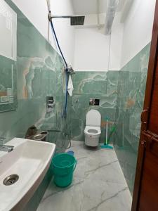 a bathroom with a sink and a toilet at aadi shakti palace in Faizābād +6 photos
