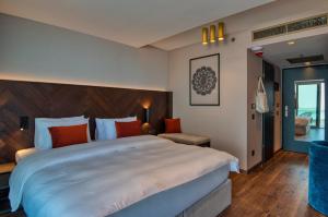 a bedroom with a large white bed in a room at Hotel Vinifera Wine & Spa 5 Stars Superior in Balatonfüred