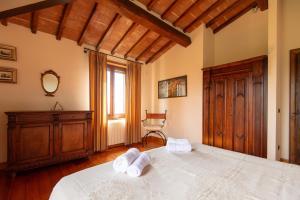 a bedroom with a large bed with towels on it at Villa Missiano Unità Cassiopea con Piscina in Panicale +36 photos