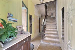 a hallway with stairs in a home with a mirror at B&B Le Miroir aux Fées Bordeaux in Bordeaux