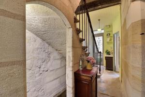 a hallway of a house with a white brick wall at B&B Le Miroir aux Fées Bordeaux in Bordeaux