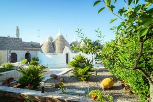 a garden with some plants and a building at I Trulli di Anna in Locorotondo
