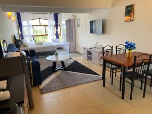 a living room with a table and a dining room at Diani dreams Villa in Ukunda
