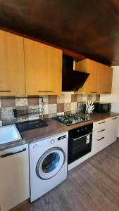 a kitchen with a washing machine and a stove at Prestigieux appartement in Hammam Sousse