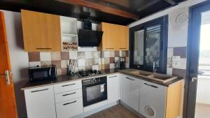 a kitchen with white cabinets and a stove top oven at Prestigieux appartement in Hammam Sousse
