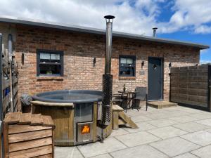 a brick building with a fire pit in a patio at Robins Nest in York