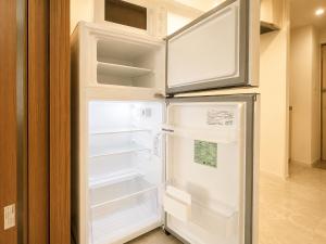 an empty refrigerator with its door open in a kitchen at Hotel Arashi Tengachaya No005 in Osaka