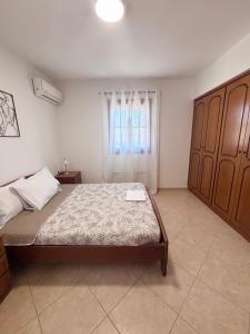 a bedroom with a bed and a window at Ocean Peak Villa in Kalymnos