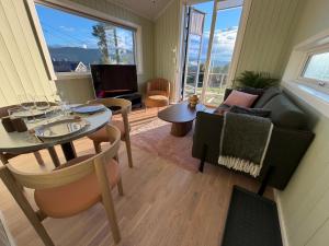 a living room with a table and a couch at Ljoshaugen Camping in Dombås