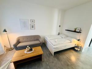 a living room with a couch and a coffee table at Apartmány pod zvonicí, Vimperk in Vimperk
