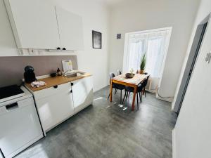 a kitchen with a table and a dining room at Apartmány pod zvonicí, Vimperk in Vimperk +5 photos