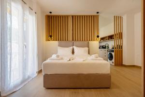 a bedroom with a large bed with towels on it at Elysian suite in Parga