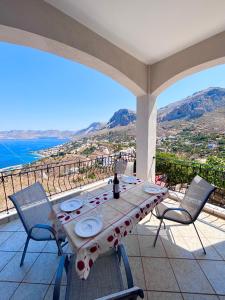 a table on a balcony with a view of the ocean at Ocean Peak Villa in Kalymnos