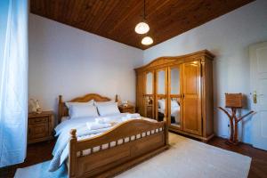 a bedroom with a wooden bed and a wooden cabinet at Maison Des Oliviers in Herceg-Novi +26 photos