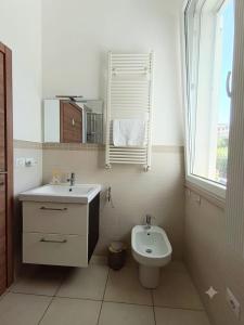 a bathroom with a sink and a toilet at Free Parking a 100 mt dal mare-Wave HuoSe in Pesaro +22 photos