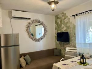 a living room with a refrigerator and a mirror at Beach House Hvar in Zastražišće