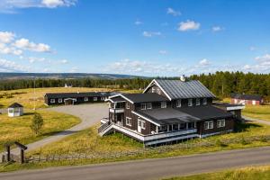 an aerial view of a large house with a road at Stølsdokken Lodge in Sanderstølen