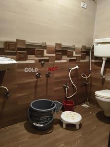 a bathroom with a sink and a toilet and a bucket at Rutam villa in Shendi