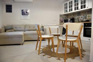a living room with three chairs and a couch at Samothrakis Michelangelo 401 in Samothraki