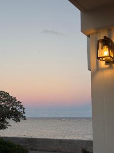a view of the ocean at sunset from a building at HERO VILLA ocean suite in Ishigaki Island +37 photos