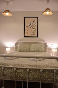 a bedroom with a large bed with two lights at Samothrakis Michelangelo 401 in Samothraki