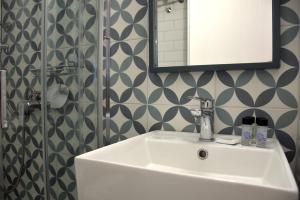 a bathroom with a sink and a mirror at Samothrakis Michelangelo 401 in Samothraki