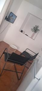 a black chair sitting in the middle of a room at Casa Olivia in Margno