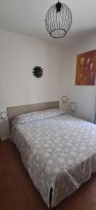 a bedroom with a bed and a pendant light at Casa Olivia in Margno +4 photos
