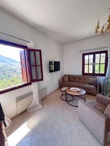 a living room with a couch and a table at Ocean Peak Villa in Kalymnos