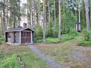a small cabin in the middle of a forest at Honkala Cottage in Keyritty