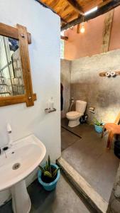 a bathroom with a sink and a toilet at Farming Tree House in Sigiriya